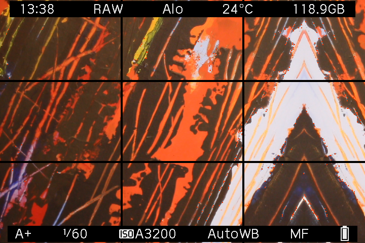 EOS M LiveView showing orange and black artwork reflected into a triangular pattern